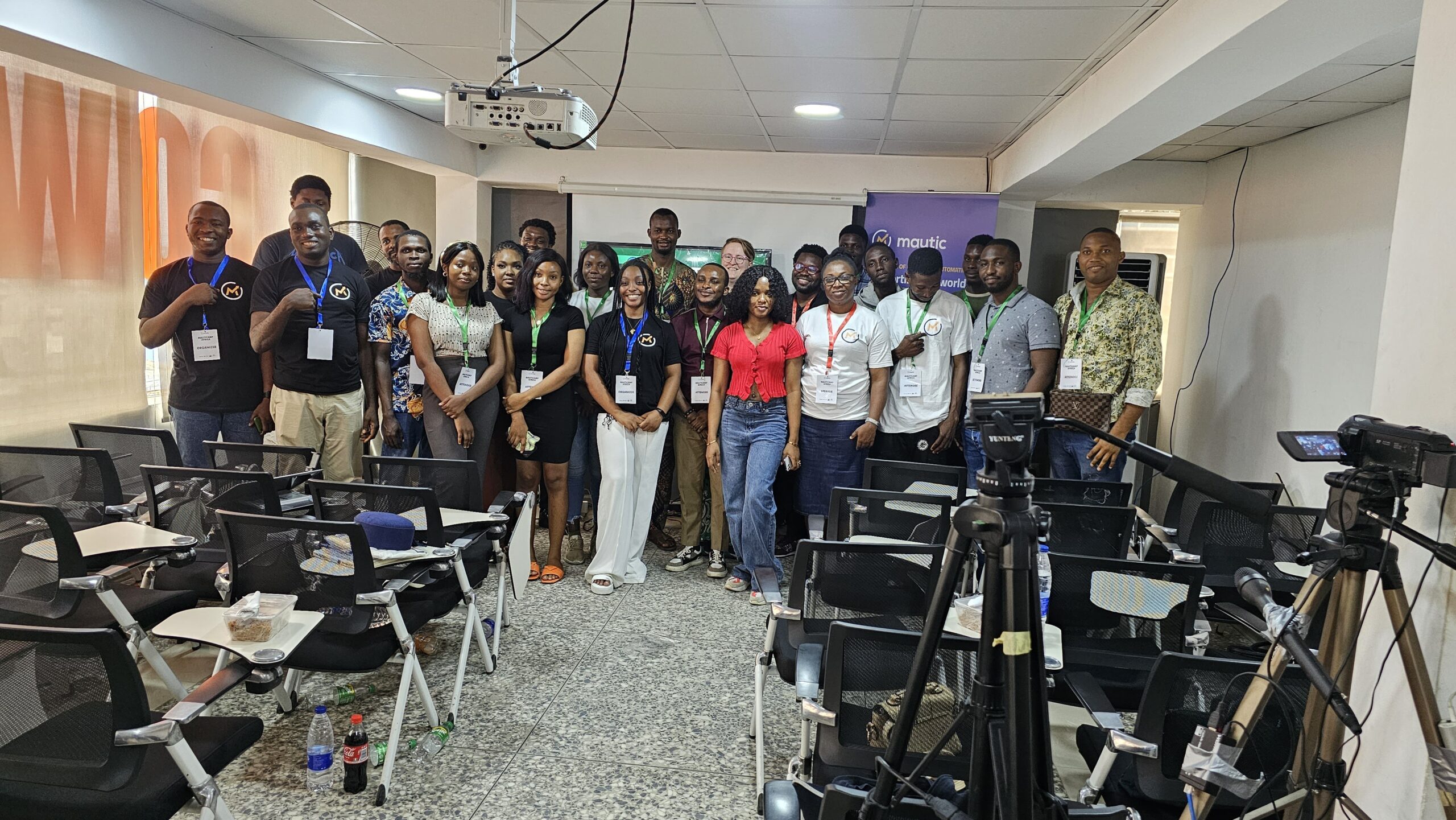 Photo of many attendees at MautiCamp Africa standing at the front of a classroom.